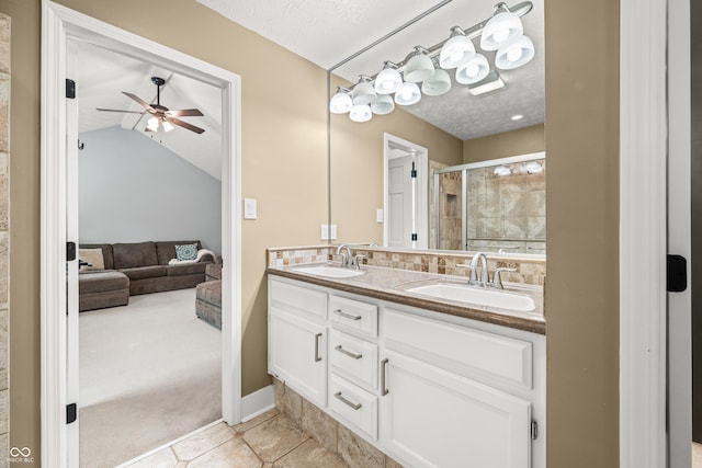 7833 Meadow Bend Dr, Indianapolis, IN 46259 - full bath with double vanity, a shower stall, ceiling fan, connected bathroom, and a textured ceiling