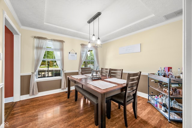 7833 Meadow Bend Dr, Indianapolis, IN 46259 - dining room featuring a tray ceiling, wood finished floors, crown molding, and baseboards