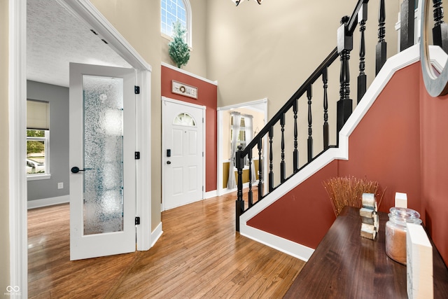 7833 Meadow Bend Dr, Indianapolis, IN 46259 - foyer entrance featuring wood finished floors, baseboards, stairway, and a towering ceiling