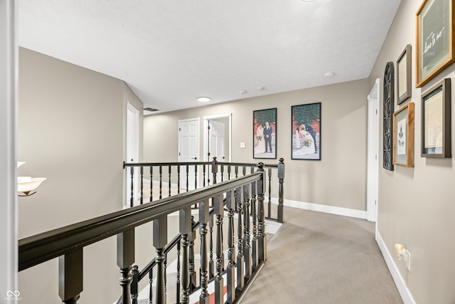 7833 Meadow Bend Dr, Indianapolis, IN 46259 - hall featuring an upstairs landing, light colored carpet, baseboards, and a textured ceiling