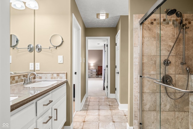 7833 Meadow Bend Dr, Indianapolis, IN 46259 - full bathroom with a stall shower, double vanity, tile patterned floors, baseboards, and a textured ceiling