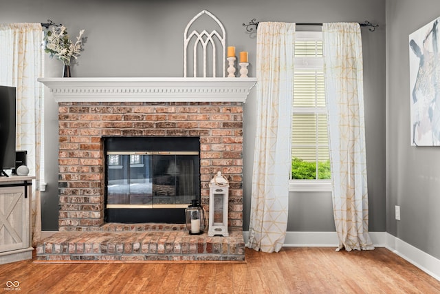 7833 Meadow Bend Dr, Indianapolis, IN 46259 - detailed view of wood finished floors, baseboards, and a fireplace