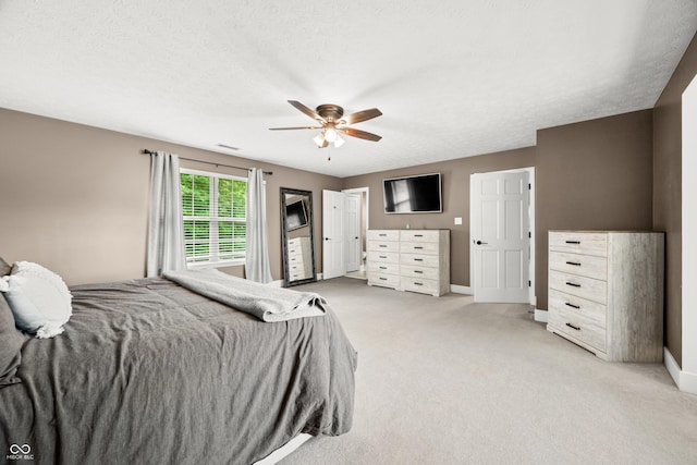7833 Meadow Bend Dr, Indianapolis, IN 46259 - bedroom with baseboards, light colored carpet, a textured ceiling, and ceiling fan