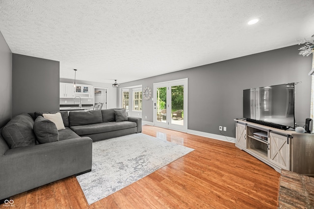 7833 Meadow Bend Dr, Indianapolis, IN 46259 - living area featuring a textured ceiling, light wood-type flooring, baseboards, and recessed lighting