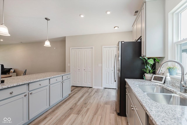 3643 Thomas Jefferson St, Westfield, IN 46074 - kitchen with light wood-style flooring, decorative light fixtures, light stone counters, and recessed lighting