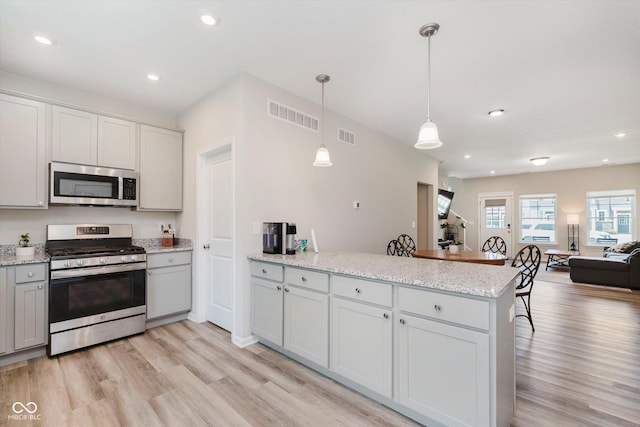 3643 Thomas Jefferson St, Westfield, IN 46074 - kitchen with appliances with stainless steel finishes, a peninsula, open floor plan, light wood-type flooring, and recessed lighting