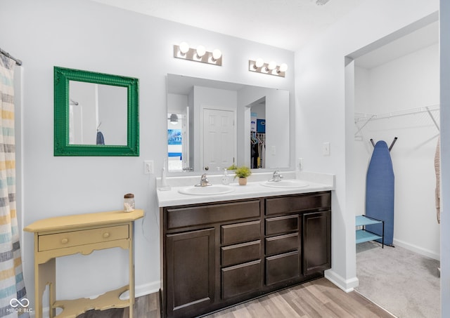12105 Fall Ct, Indianapolis, IN 46229 - full bathroom with a spacious closet, double vanity, and wood finished floors
