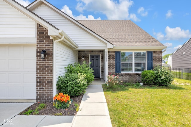12105 Fall Ct, Indianapolis, IN 46229 - view of exterior entry with brick siding, a garage, and roof with shingles