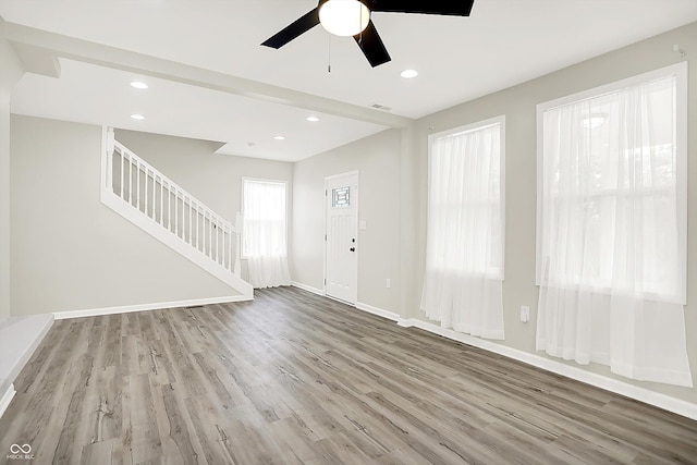 1338 N Parker Ave, Indianapolis, IN 46201 - unfurnished living room featuring wood finished floors, stairs, ceiling fan, baseboards, and recessed lighting