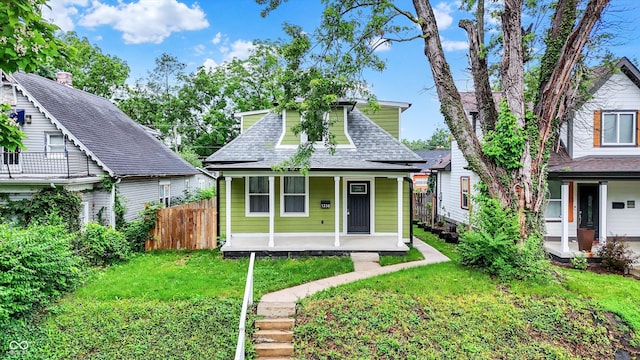 1338 N Parker Ave, Indianapolis, IN 46201 - view of front facade featuring covered porch and a shingled roof
