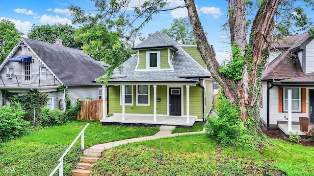 1338 N Parker Ave, Indianapolis, IN 46201 - bungalow featuring covered porch and roof with shingles