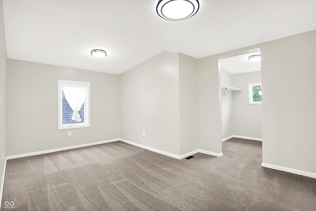 1338 N Parker Ave, Indianapolis, IN 46201 - spare room featuring dark colored carpet and baseboards