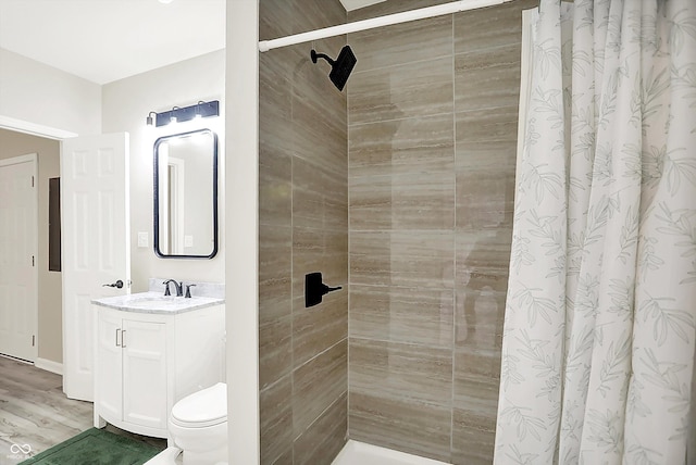 1338 N Parker Ave, Indianapolis, IN 46201 - bathroom featuring vanity, a tile shower, toilet, and wood finished floors