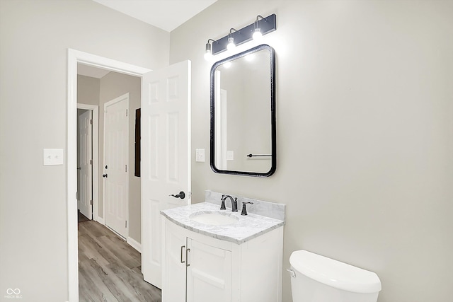1338 N Parker Ave, Indianapolis, IN 46201 - bathroom with vanity, toilet, and wood finished floors
