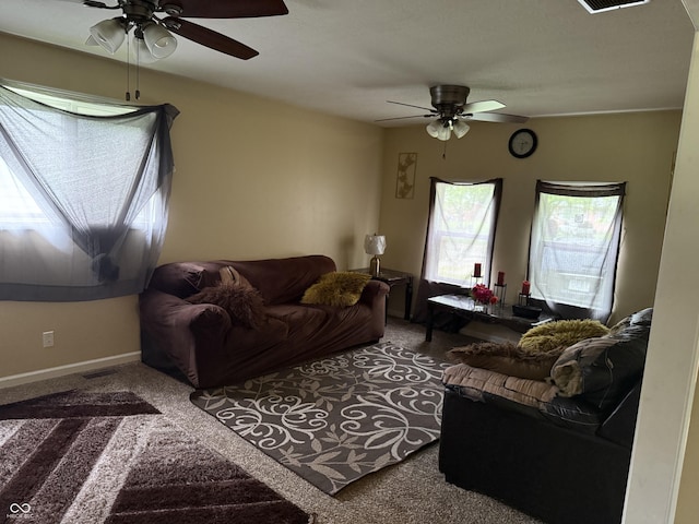carpeted living room featuring ceiling fan and baseboards