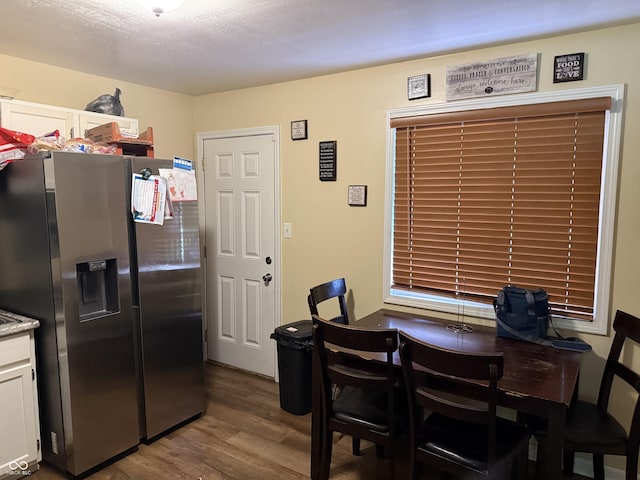 dining space featuring wood finished floors and a desk