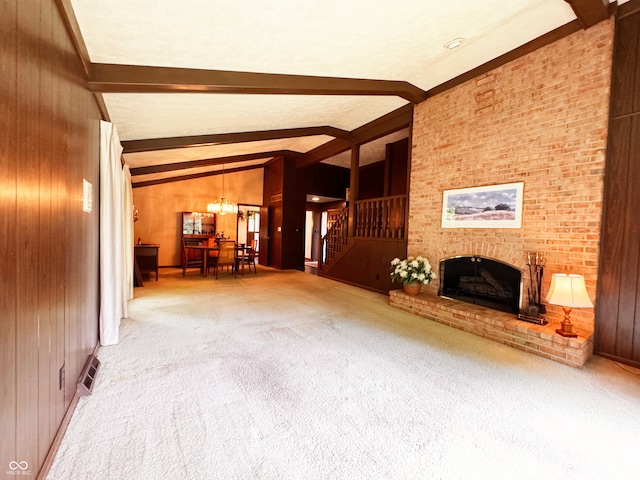 7038 E 65th St, Indianapolis, IN 46256 - unfurnished living room with wood walls, stairway, carpet floors, a chandelier, and a fireplace