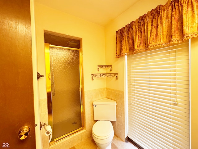 7038 E 65th St, Indianapolis, IN 46256 - bathroom with tile walls, tile patterned floors, a shower stall, and a wainscoted wall