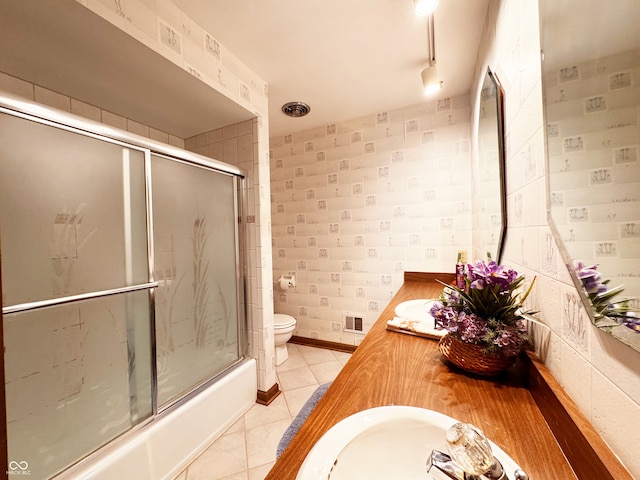 7038 E 65th St, Indianapolis, IN 46256 - bathroom with double vanity, enclosed tub / shower combo, and tile patterned floors