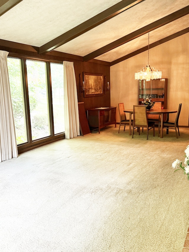 7038 E 65th St, Indianapolis, IN 46256 - dining space with beamed ceiling, carpet flooring, a chandelier, and wooden walls