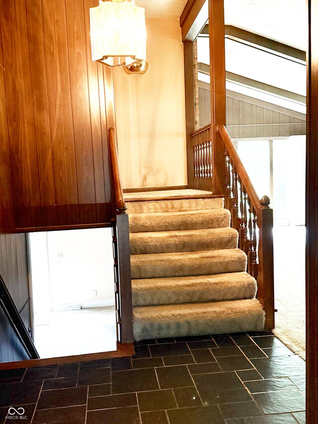 7038 E 65th St, Indianapolis, IN 46256 - stairway with wooden walls and stone finish floors