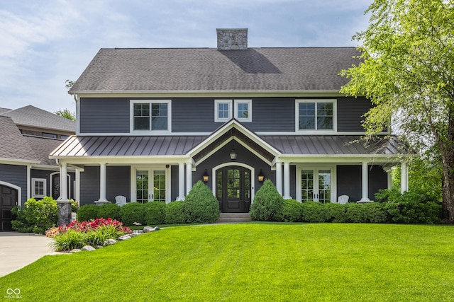 10974 Harbor Bay Dr, Fishers, IN 46040 - view of front of property featuring a standing seam roof, french doors, a front yard, a metal roof, and a shingled roof