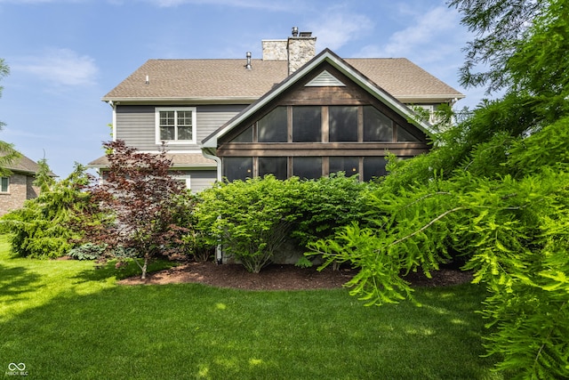 10974 Harbor Bay Dr, Fishers, IN 46040 - back of house with a lawn, a chimney, and a shingled roof