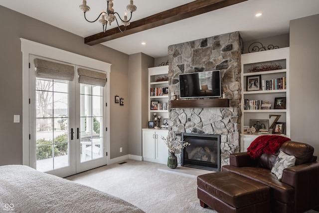10974 Harbor Bay Dr, Fishers, IN 46040 - carpeted living area with a chandelier, a stone fireplace, beam ceiling, and french doors