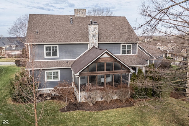 10974 Harbor Bay Dr, Fishers, IN 46040 - rear view of house with a chimney, a shingled roof, a sunroom, and a yard