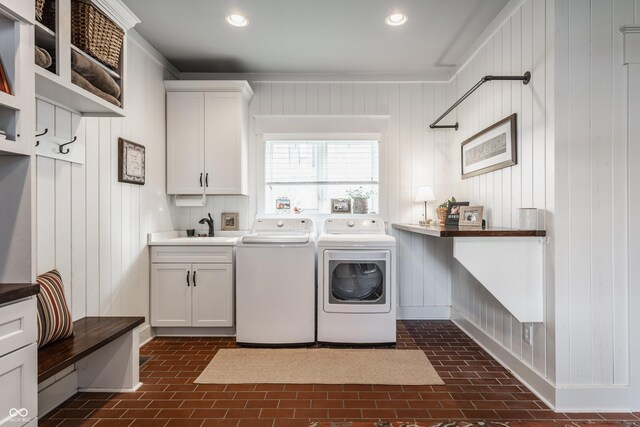 10974 Harbor Bay Dr, Fishers, IN 46040 - laundry area with brick floors, washer and clothes dryer, cabinet space, recessed lighting, and ornamental molding