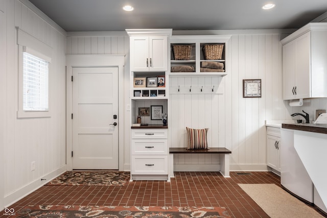 10974 Harbor Bay Dr, Fishers, IN 46040 - mudroom featuring brick patterned floors, recessed lighting, and wooden walls