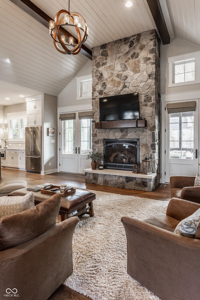 10974 Harbor Bay Dr, Fishers, IN 46040 - living area featuring wood finished floors, a chandelier, a stone fireplace, a wood ceiling with exposed beams, and high vaulted ceiling