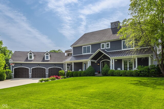 10974 Harbor Bay Dr, Fishers, IN 46040 - view of front of property with an attached garage, a standing seam roof, a front yard, and driveway