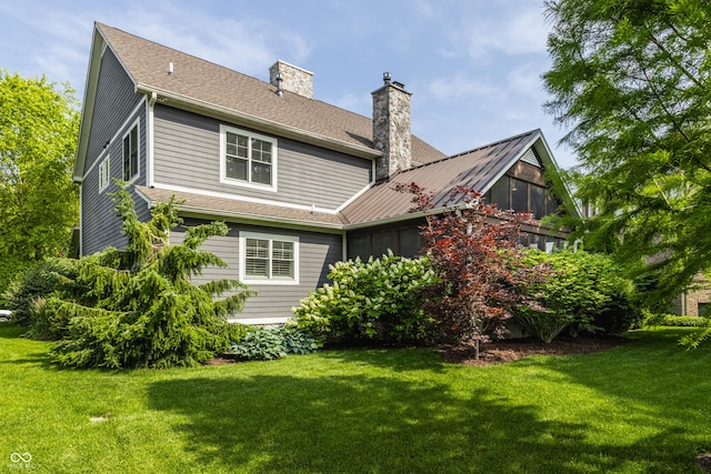 10974 Harbor Bay Dr, Fishers, IN 46040 - back of house featuring a chimney and a yard