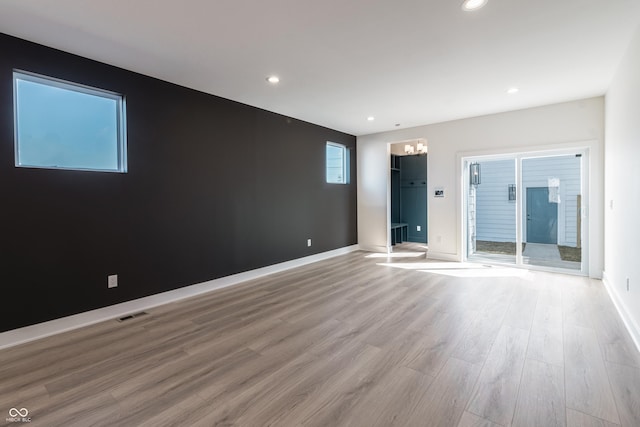 2051-2053 Columbia Ave, Indianapolis, IN 46202 - spare room with a chandelier, light wood-type flooring, baseboards, and recessed lighting