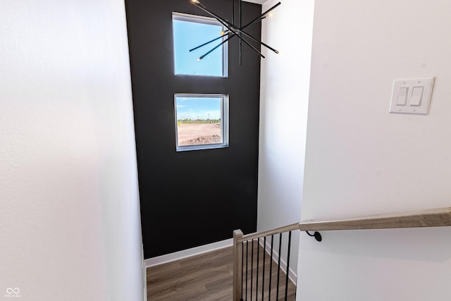 2051-2053 Columbia Ave, Indianapolis, IN 46202 - stairs with a chandelier, wood finished floors, and baseboards