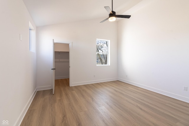 2051-2053 Columbia Ave, Indianapolis, IN 46202 - spare room with light wood-type flooring, ceiling fan, baseboards, and lofted ceiling