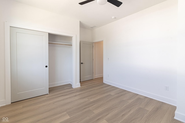 2051-2053 Columbia Ave, Indianapolis, IN 46202 - unfurnished bedroom with light wood-style flooring, baseboards, a closet, and ceiling fan