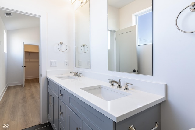 2051-2053 Columbia Ave, Indianapolis, IN 46202 - bathroom with double vanity, wood finished floors, and baseboards