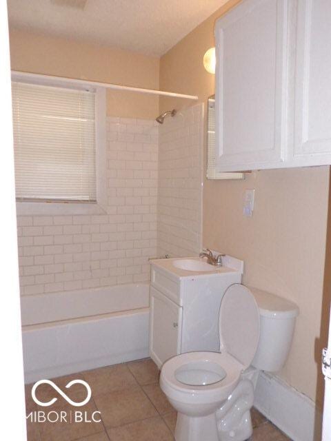 2250 N Goodlet Ave, Indianapolis, IN 46222 - bathroom with vanity, tub / shower combination, and tile patterned floors