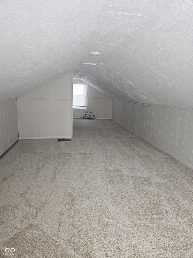 2250 N Goodlet Ave, Indianapolis, IN 46222 - bonus room with a textured ceiling, lofted ceiling, and carpet flooring