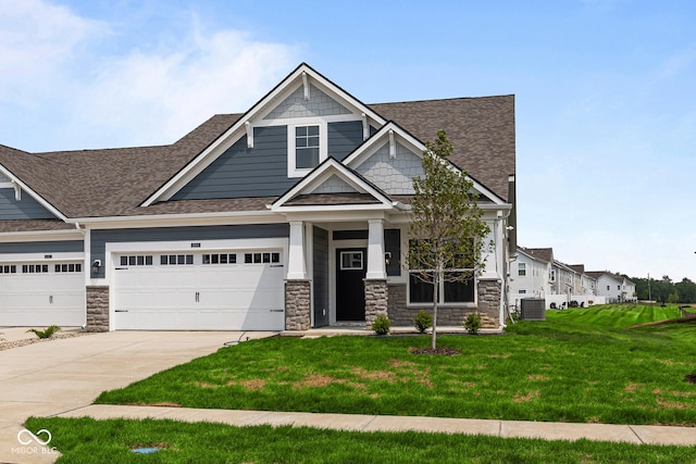 12500 Morning Ridge Way, Noblesville, IN 46060 - craftsman house featuring roof with shingles, a front lawn, concrete driveway, and stone siding
