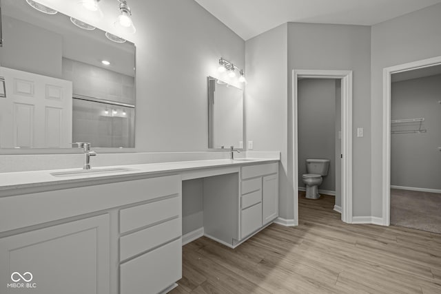 12500 Morning Ridge Way, Noblesville, IN 46060 - full bath with double vanity, a tile shower, toilet, wood finished floors, and baseboards
