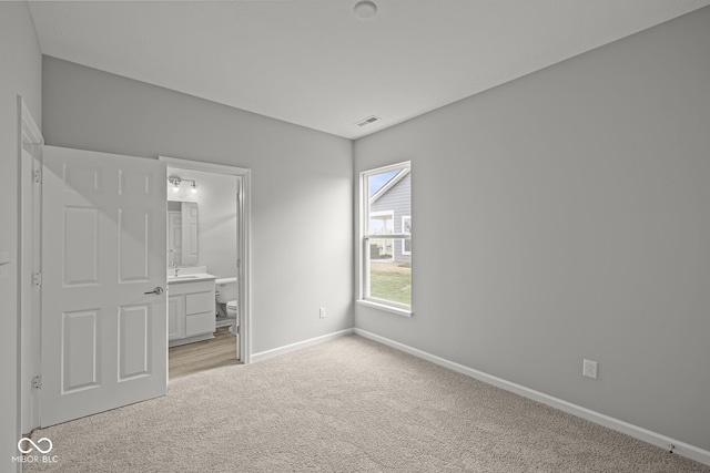 12500 Morning Ridge Way, Noblesville, IN 46060 - unfurnished bedroom featuring light carpet, baseboards, and ensuite bathroom