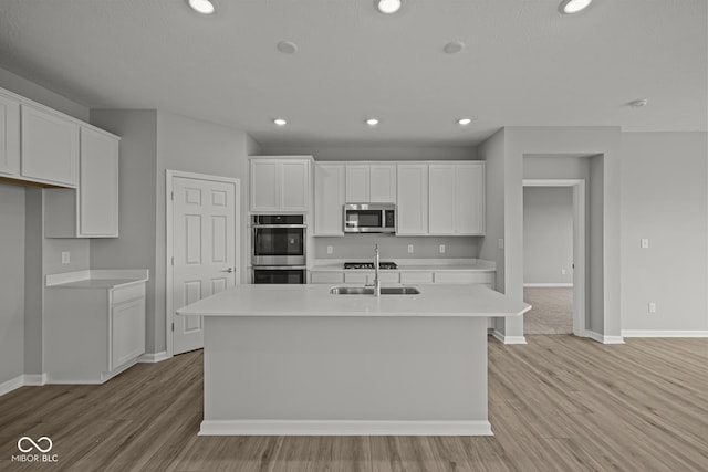 12500 Morning Ridge Way, Noblesville, IN 46060 - kitchen with stainless steel appliances, baseboards, white cabinets, light countertops, and recessed lighting