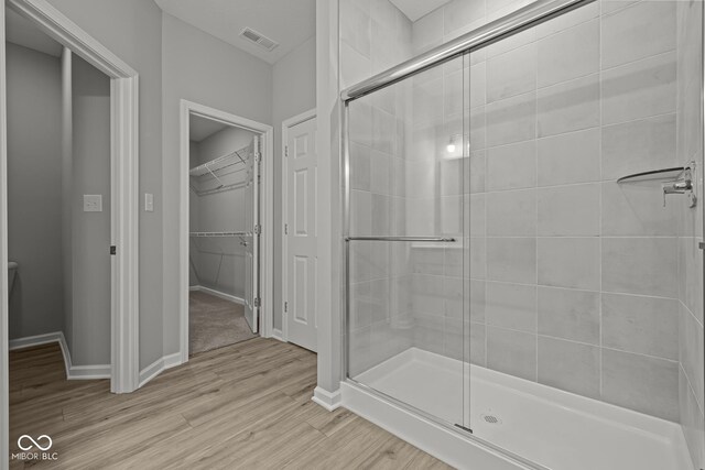 12500 Morning Ridge Way, Noblesville, IN 46060 - full bathroom with a shower stall, wood finished floors, a walk in closet, and baseboards