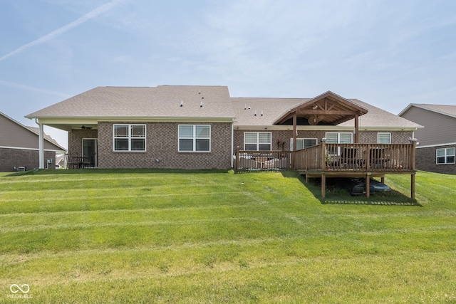 8842 Twain Ln, Indianapolis, IN 46239 - back of house with a yard, a wooden deck, ceiling fan, and brick siding