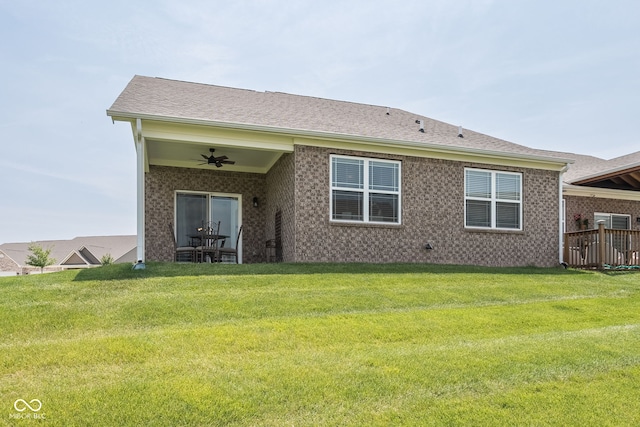 8842 Twain Ln, Indianapolis, IN 46239 - rear view of property featuring a ceiling fan, a lawn, and brick siding