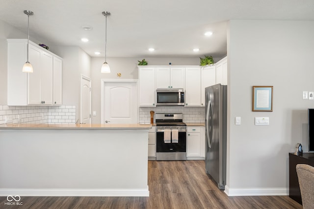 8842 Twain Ln, Indianapolis, IN 46239 - kitchen featuring appliances with stainless steel finishes, dark wood-type flooring, decorative backsplash, white cabinetry, and recessed lighting