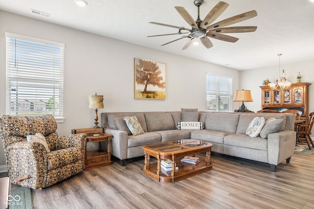 8842 Twain Ln, Indianapolis, IN 46239 - living room with wood finished floors, ceiling fan, and a chandelier